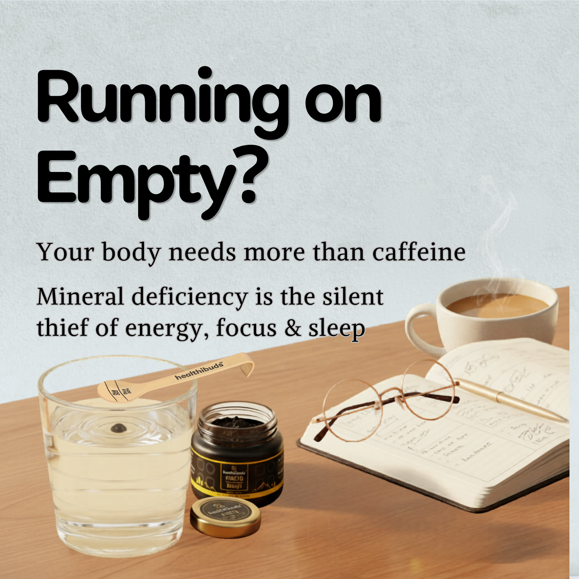 A wellness-themed promotional graphic with the text 'Running on Empty?' and supporting copy about mineral deficiency and lack of energy. The scene shows a glass of pale yellow liquid, a small jar with its lid off, a wooden spoon labeled 'Selenium', an open notebook with glasses on top, and a cup of coffee on a wooden table against a pale blue background.