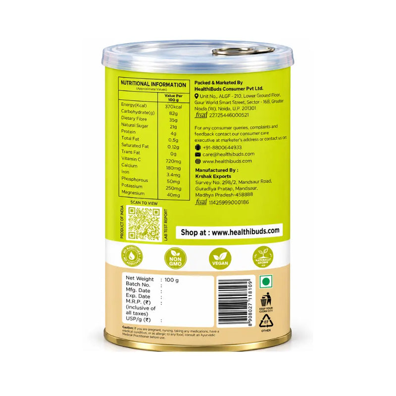 Amla powder tin with spoon and fresh amla on white background