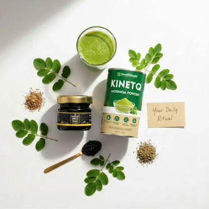 Health products including a jar, a can, and a glass of green juice on a white background with leaves.