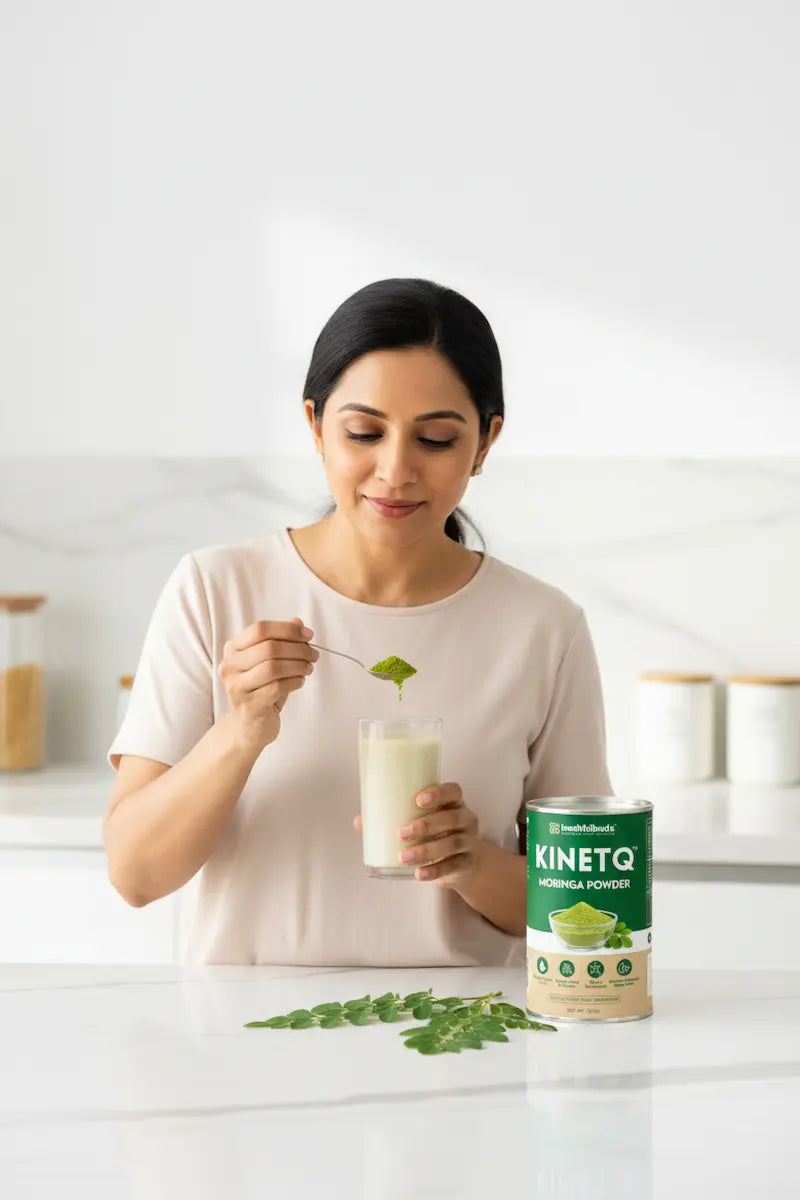 Woman holding a glass of milk with a spoon, next to a container of KINETO matcha powder.