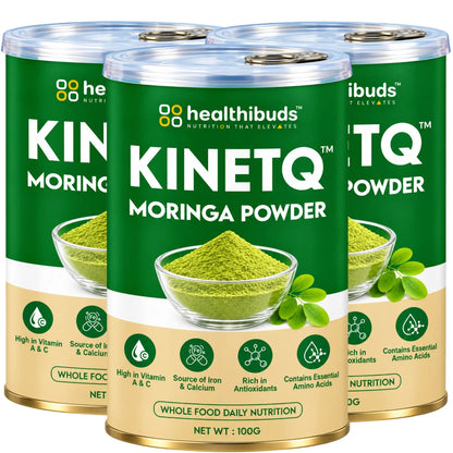 Three cans of Healthibuds Kinetq Moringa Powder arranged together on a plain white background, showing the product packaging with green and beige labels and a bowl of green powder illustration.