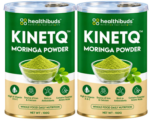 Two 100g cans of Healthibuds Kinetq Moringa Powder side by side on a white background. The cans are dark green with a beige lower section, featuring a bowl of green powder and moringa leaves on the label.