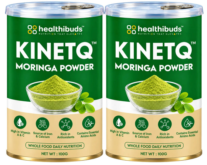 Two 100g cans of Healthibuds Kinetq Moringa Powder side by side on a white background. The cans are dark green with a beige lower section, featuring a bowl of green powder and moringa leaves on the label.